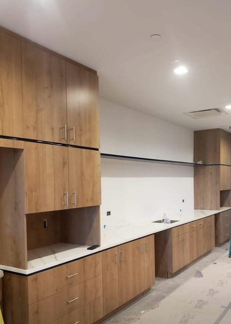 Custom kitchen cabinets in light wood with quartz countertop